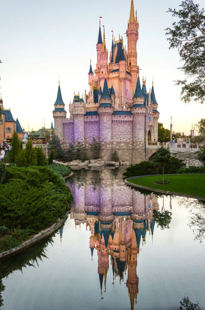 Photo of the castle at Disney World in Orlando, Florida with the reflection of the castle in the water.