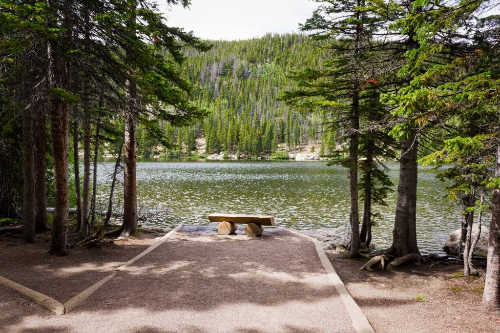 Empty bench in front of Bear Lake in Rocky Mountain National Park.