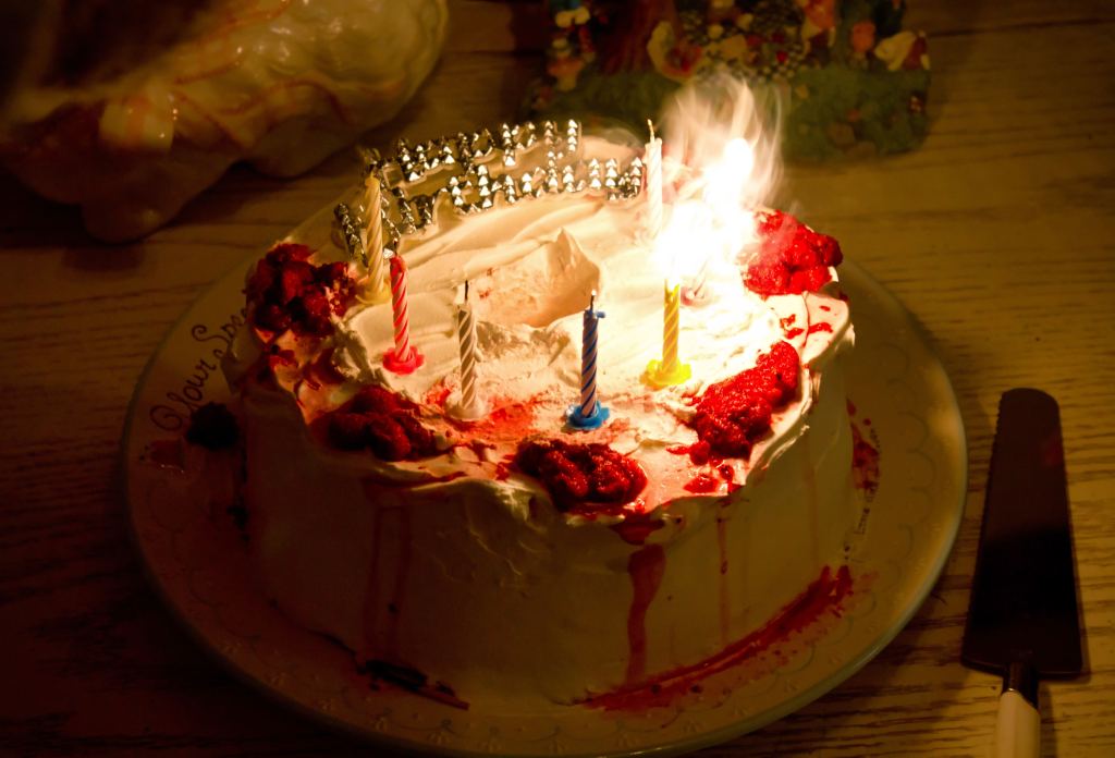 Birthday cake with candles being blown out
