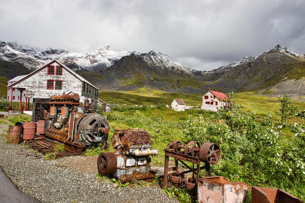 Independence Mine State Historical Park in Hatcher Pass, Alaska with snow-capped mountains in the background.